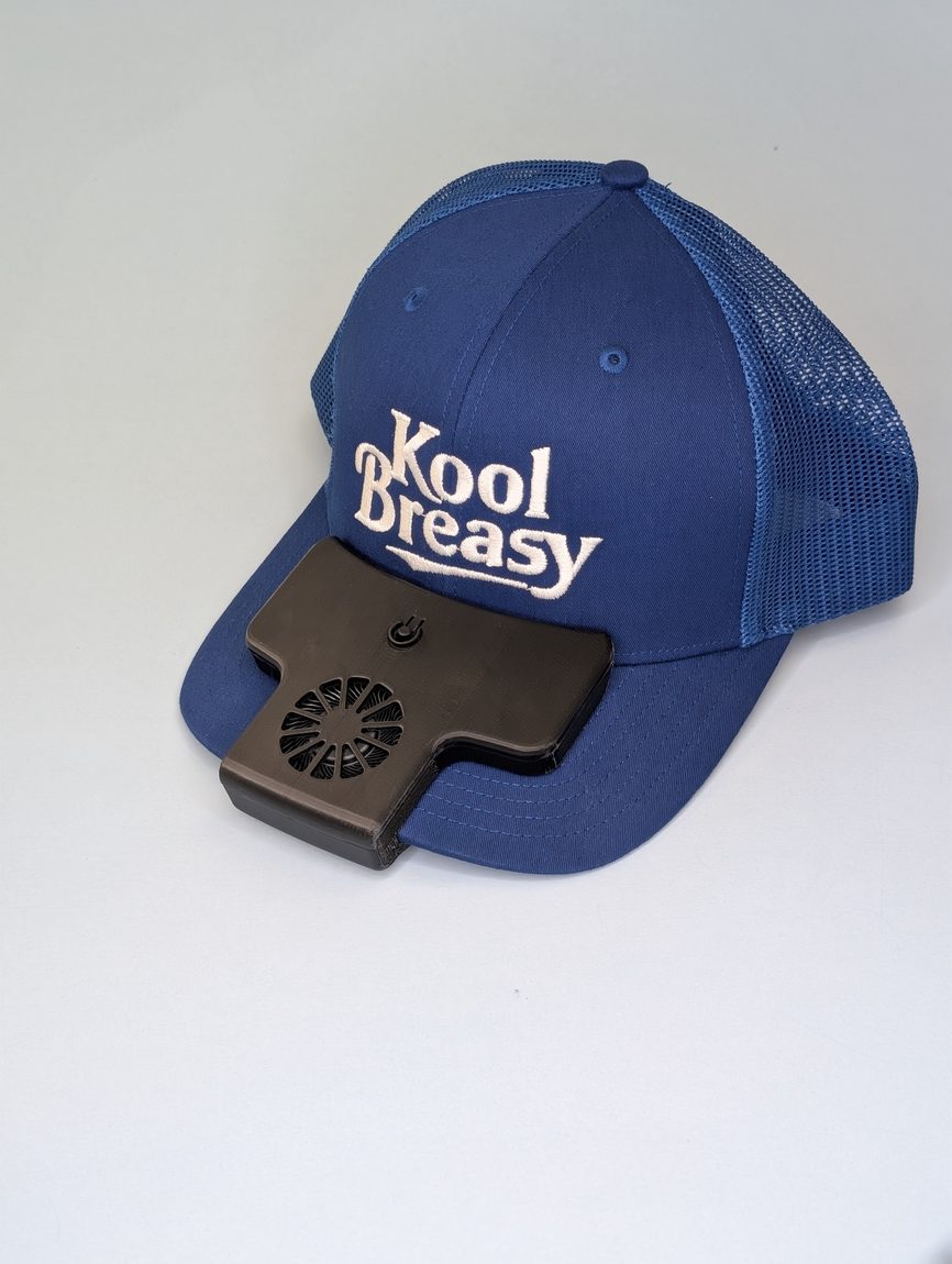 Kool Breasy fan unit slipped onto a navy trucker cap